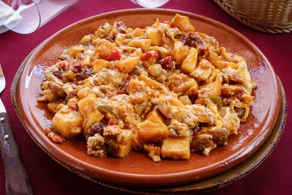 Scrambled eggs with summer vegetables medley, chorizo and potatoes